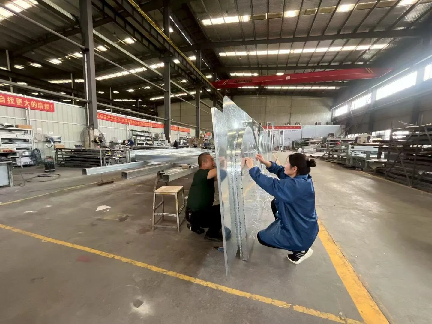 Large custom metal sign structure being assembled