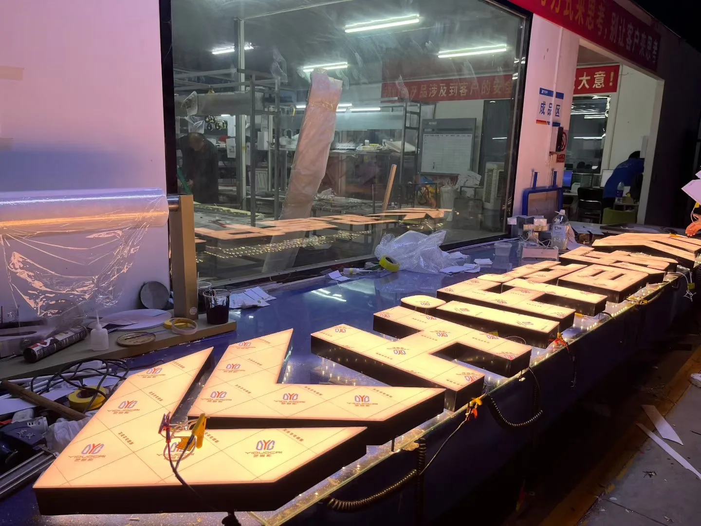 Illuminated sign components powered on during production